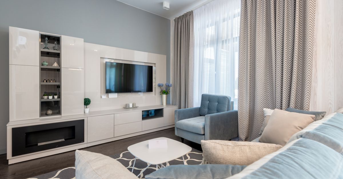 Stylish contemporary living room interior with modern furniture and blue accents.